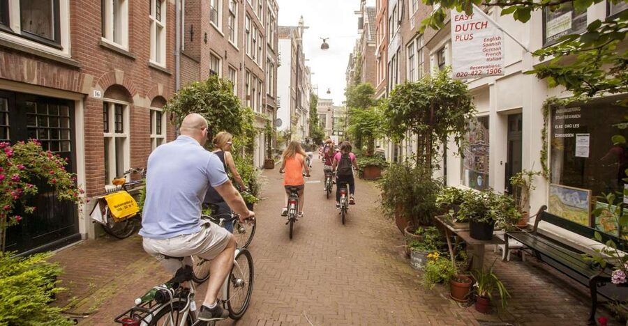 Amsterdam: Hidden Gems & Highlights Guided Bike Tour - Starting in Jordaan’s courtyards and churches
