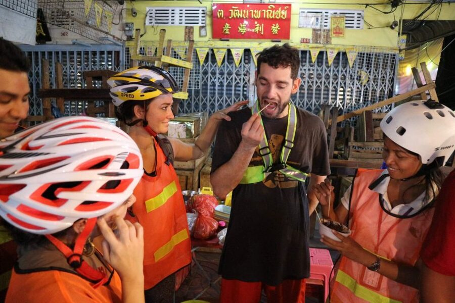 Bangkok: Night Bike Ride and Dinner at a Local Restaurant - Chinatown under neon lights