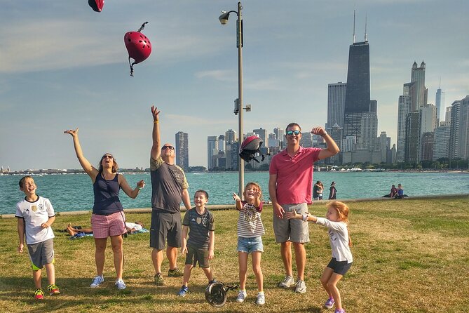 Chicago Family Food and Bike Tour with Top Attractions - The Riverwalk, marquee signs, and downtown views