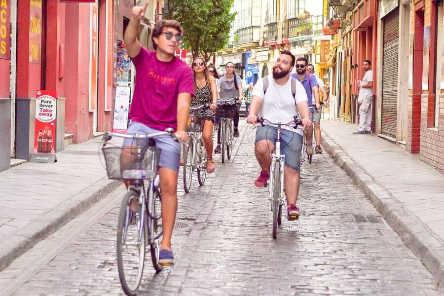 Seville: City Sightseeing and Local Culture Bike Tour - Crossing the river into Triana